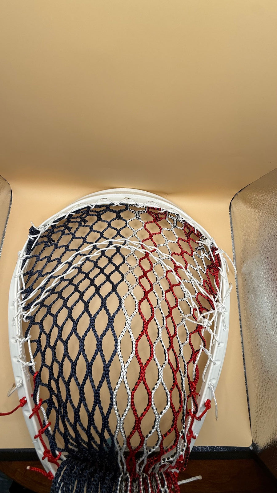 Warrior Nemesis goalie lacrosse head with red white and blue mesh