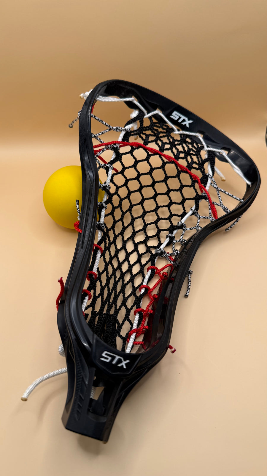STX Crux girls lacrosse head, black mesh, red and white strings